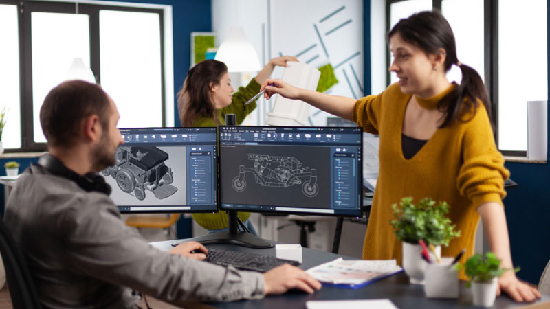 Amylior team members collaborating on adaptive mobility equipment manufacturing